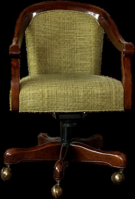 Our Founding Literacy Advisor’s green reading chair, glowing under a warm lamp